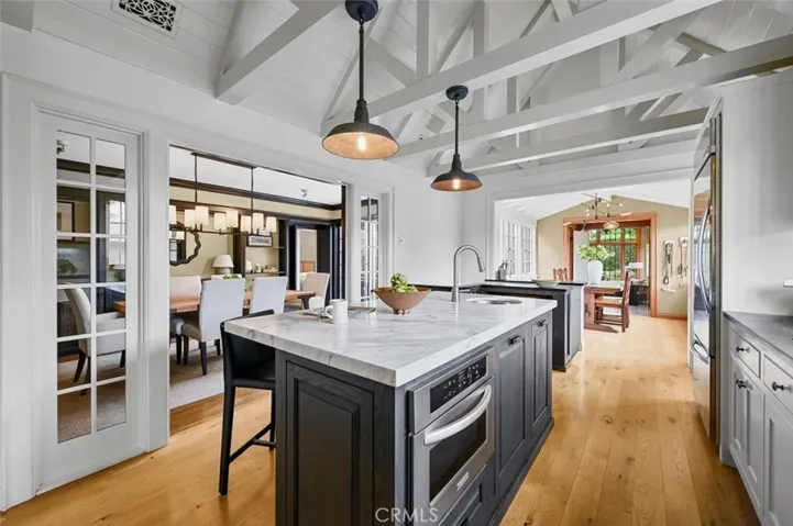 Striking open truss ceiling in the spacious kitchen.