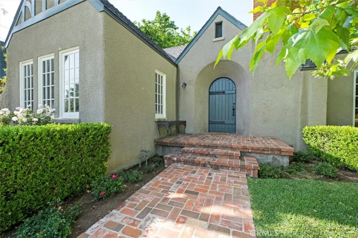 A nice elevated brick porch and original door.