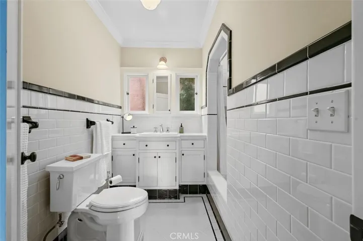 All new vintage style guest bath with black & white tiles.