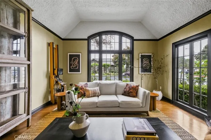 Stunning Living room with original, restored arched window and 11' tall ceilings.The perfect spot for a Christmas tree!