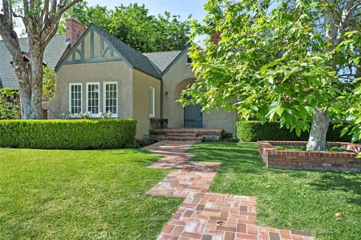 A welcoming brick walk and planter.