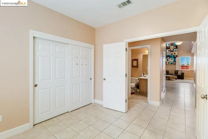 This bedroom is next to a full bathroom