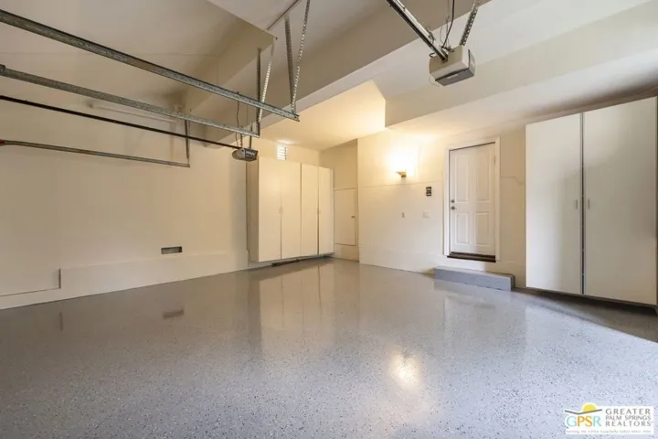 Direct access garage with new epoxied floors and loads of storage.