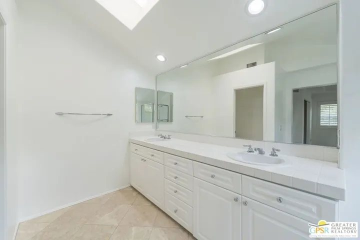 Primary bathroom with refinished vanities.