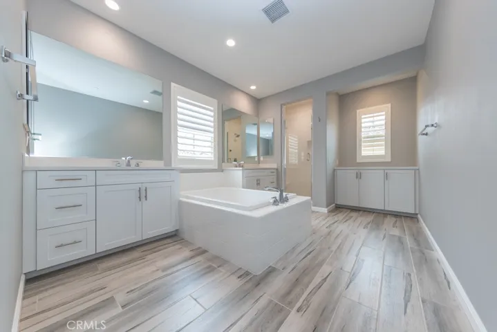 primary bedroom's ensuite bath has two separate sink areas