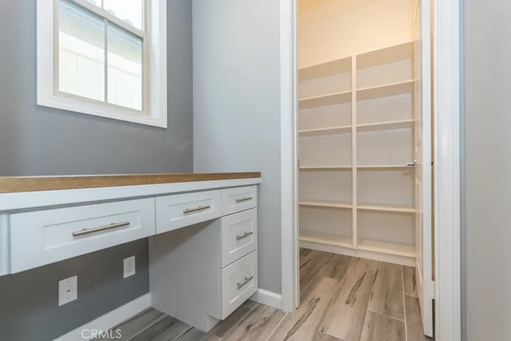 Coffee bar / desk area entered directly from kitchen, then walk-in pantry room