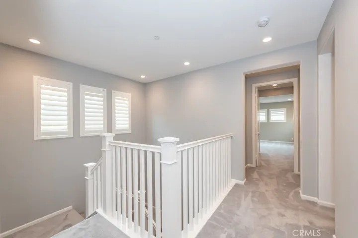 view from top of stairs looking towards bedroom 3 and primary bedroom suite