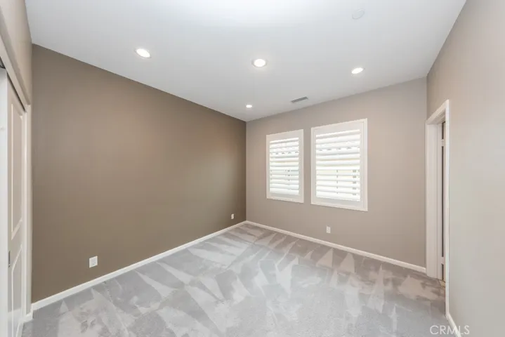entering bedroom 3 just past laundry room, also boasts its own ensuite bathroom on right