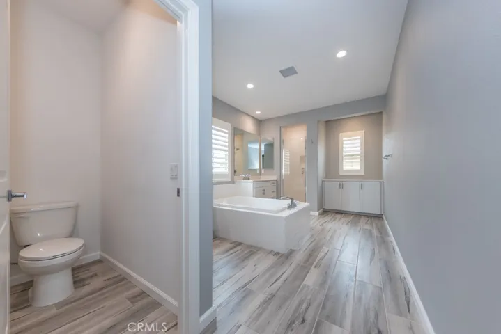huge primary bedroom's ensuite (4th) bathroom boasts separate soaking tub, shower, and storage areas