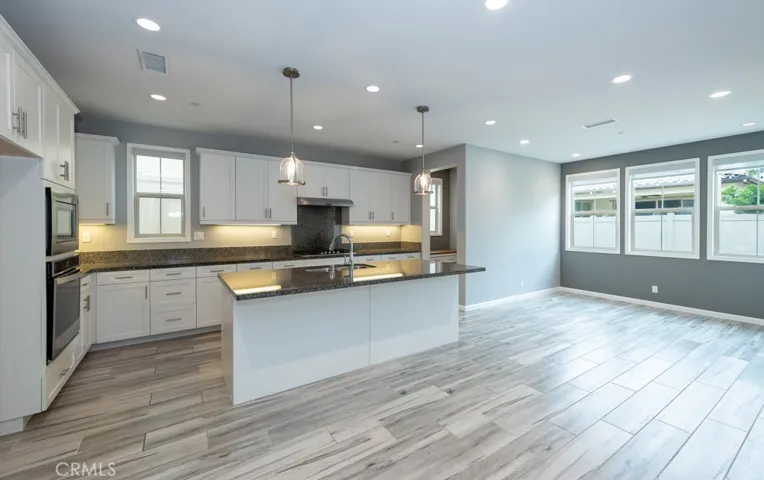 Kitchen is at left rear of house past stairs