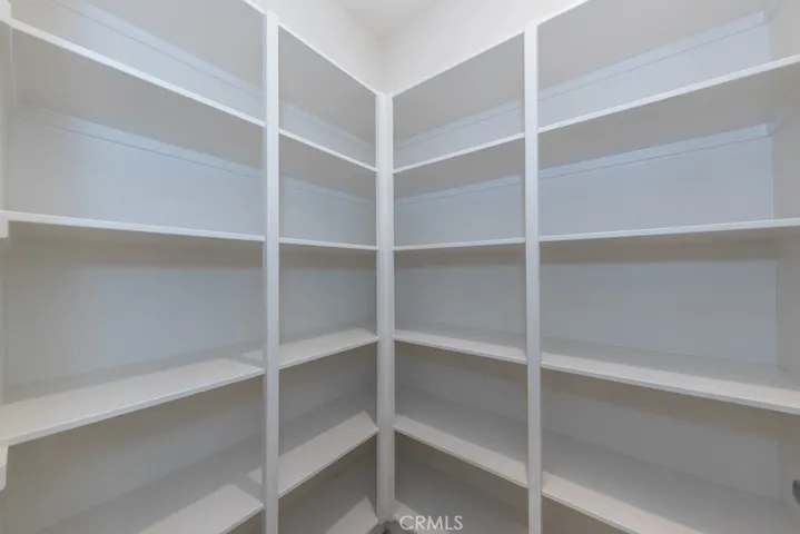 large pantry off kitchen through coffee bar