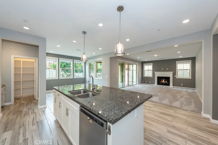 From kitchen looking towards coffee bar / pantry, dining area, den, backyard