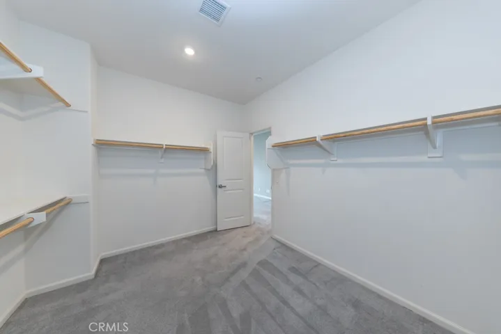 spacious primary bedroom closet is located just inside primary suite on left, opposite primary (4th) ensuite bathroom