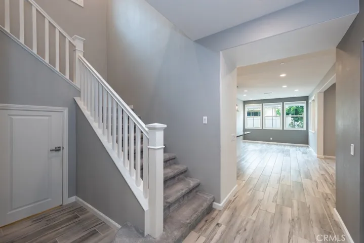 Spacious storage area under staircase on left