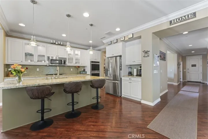 Kitchen with gorgeous window cabinets and lighting.