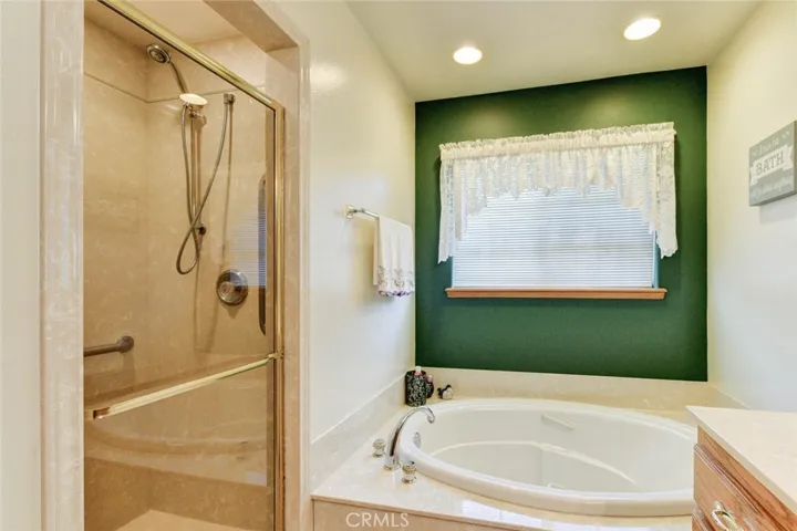 PRIMARY BATHROOM WITH A SEPARATE SHOWER AND SOAKING TUB