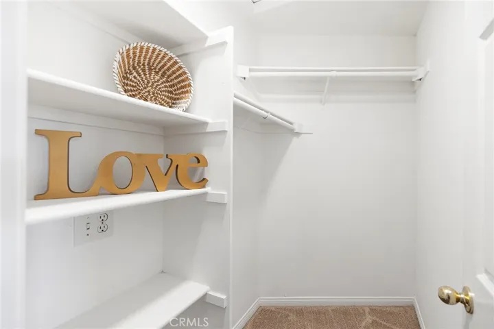 Primary walk-in closet with attic access