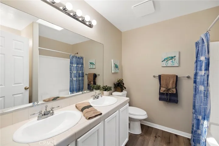Primary bath with new lighting, toilet, medicine cabinet, & hardware