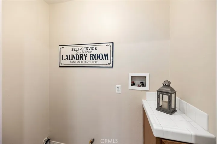 Convenient indoor laundry with counterspace and cabinet