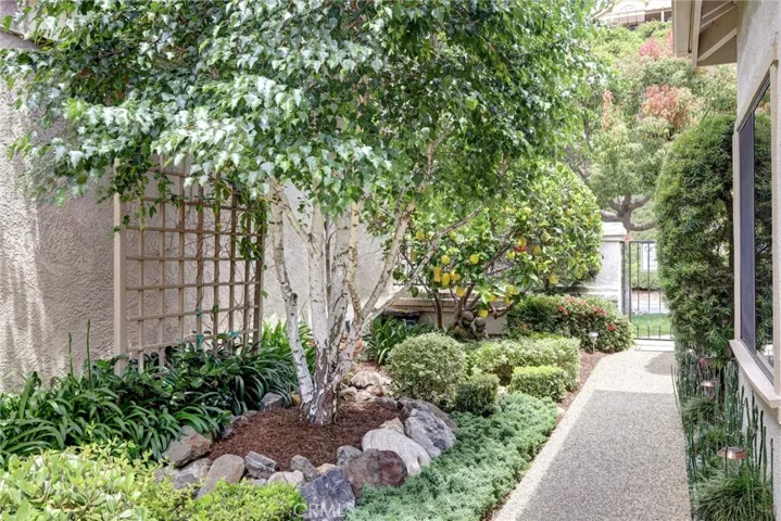 Lushly landscaped side entry