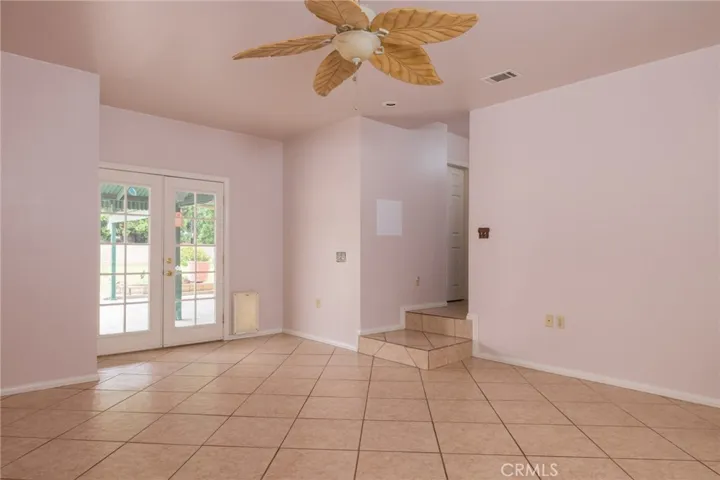 Main bedroom with French doors to the back yard