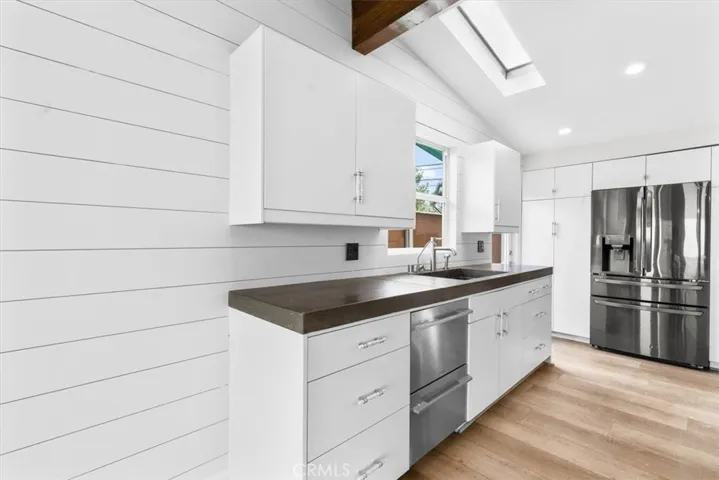 Dish washer, sink, and fridge.