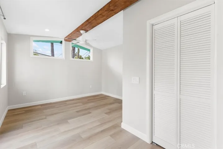one of 2 primary bedroom walk-in closets