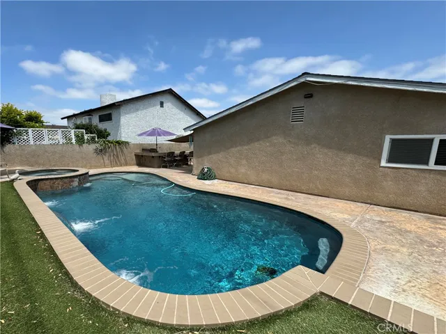Backyard with remodeled pool, stucco block walls