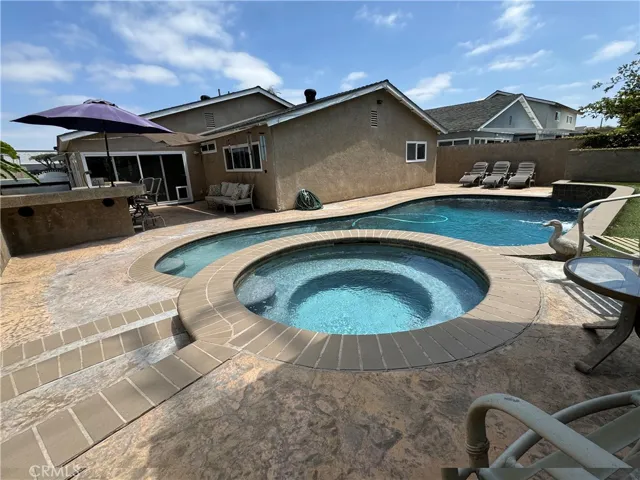 Backyard with remodeled pool, stucco block walls