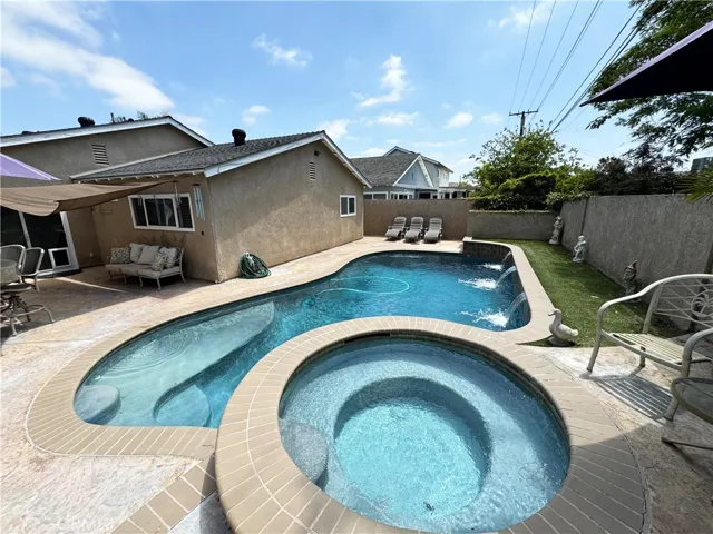 Backyard with remodeled pool, stucco block walls