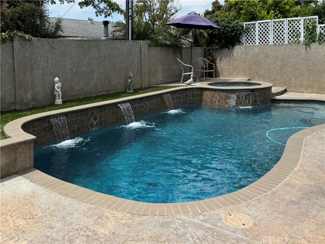 Backyard with remodeled pool, stucco block walls
