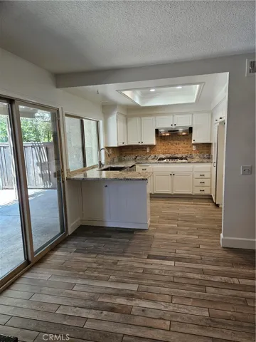 Upgraded kitchen off dining area with serene nature views from window