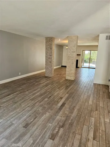 Living room and dining open floor plan with sliders to patios in front and rear patios