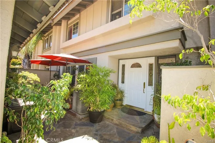 Entry door to home from gated patio entry to unit