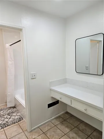 Beautiful primary bath quartz vanity across from sink