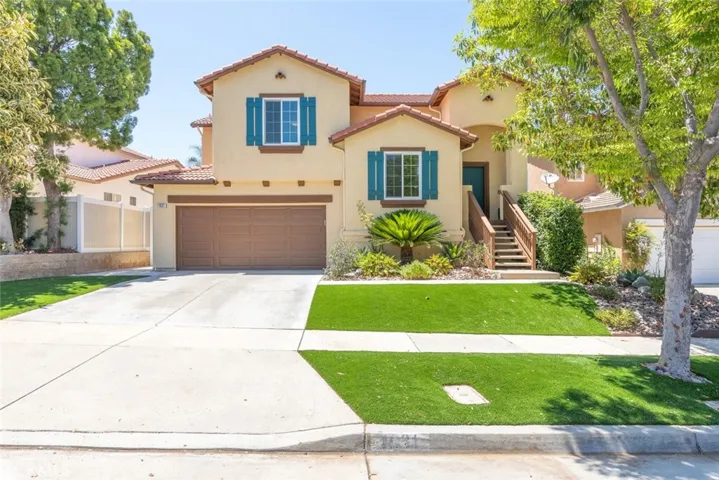 A beautiful home featuring a spacious driveway and meticulously maintained landscaping.