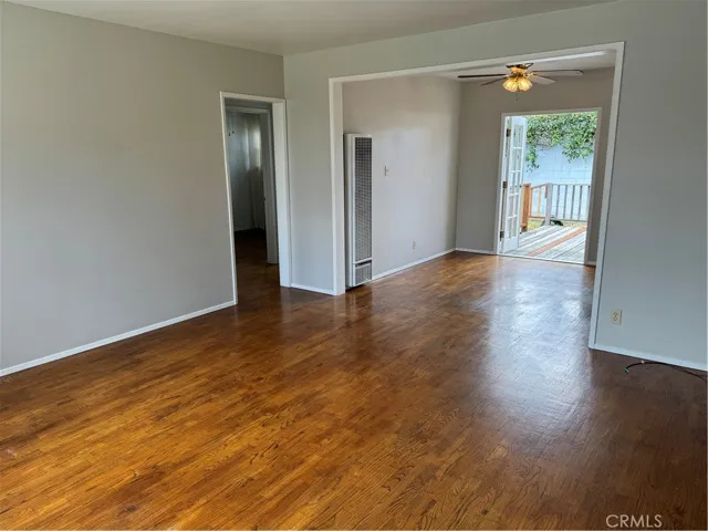 As you enter, you encounter the living room extending to the dining area, all adorned with hardwoods.