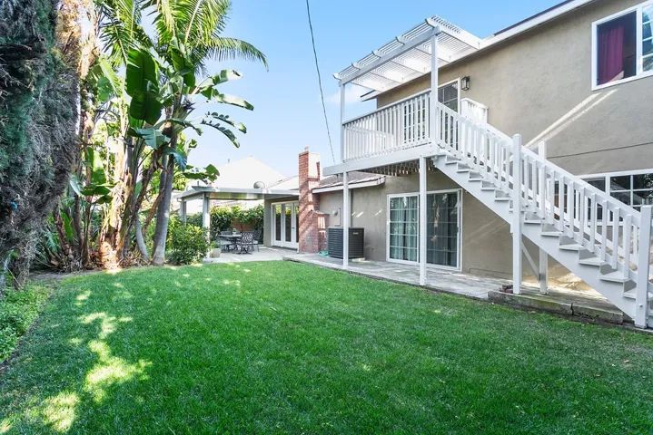 Rear yard with entrance to upstairs apartment.