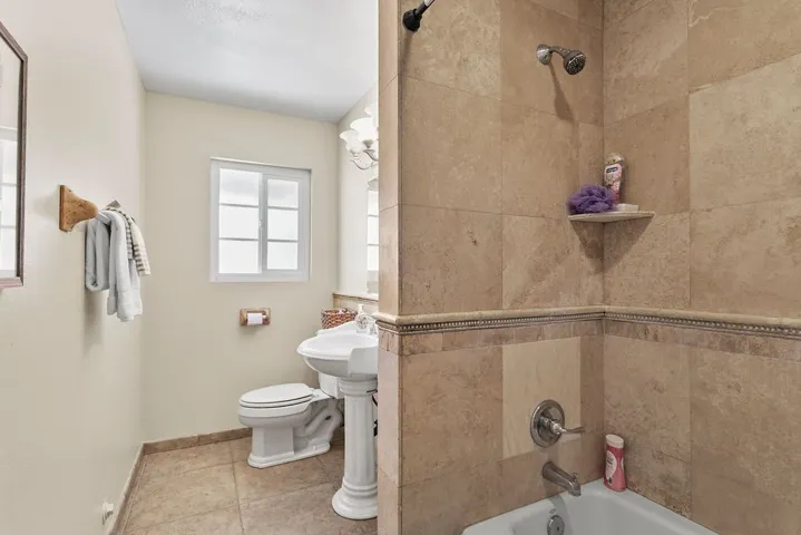 Hallway bathroom custom stone shower/bath walls.