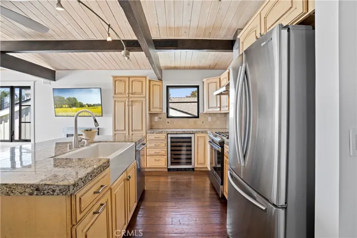  The adjacent gourmet kitchen features high end appliances and a breakfast bar perfect for casual dining.