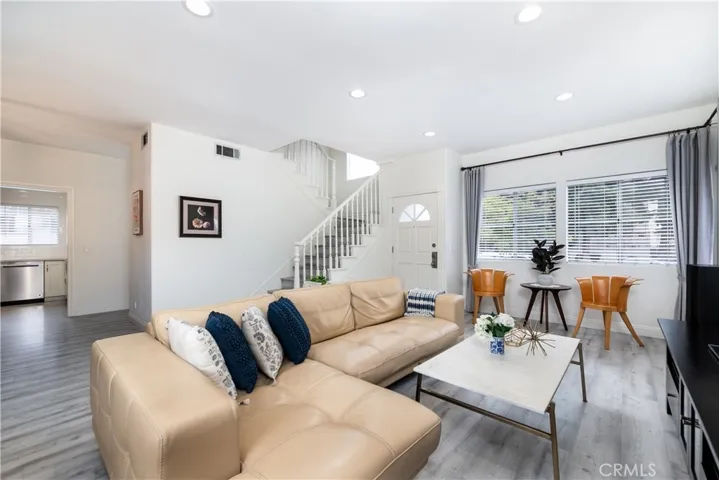 Living room with recessed lights and new engineered wood floors