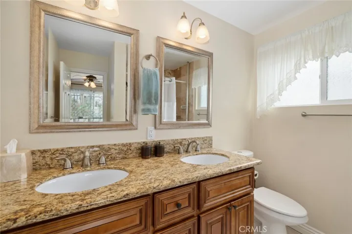 Primary bathroom with dual sinks and shower tub combo