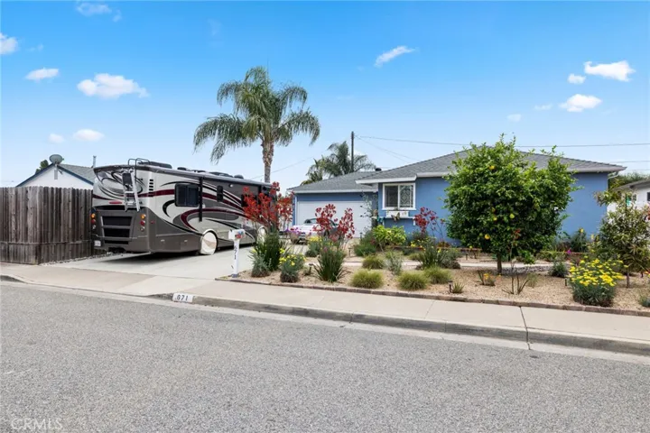 Stunning gardens, RV parking, and a large driveway accommodating up to six cars