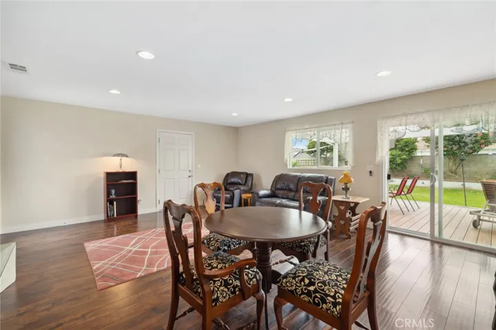 Seamless indoor-outdoor living: open kitchen, dining, & living space with deck acces