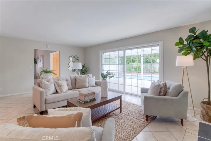 Family Room with a view of the backyard covered patio and sparkling pool~