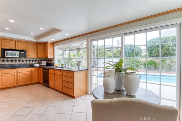 You'll enjoy cooking in the wonderful kitchen featuring an expansive garden window overlooking the backyard and sparkling pool!