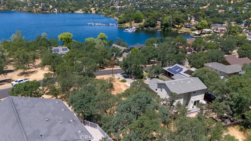 The lot is between the 2 houses and across the street from the lake.