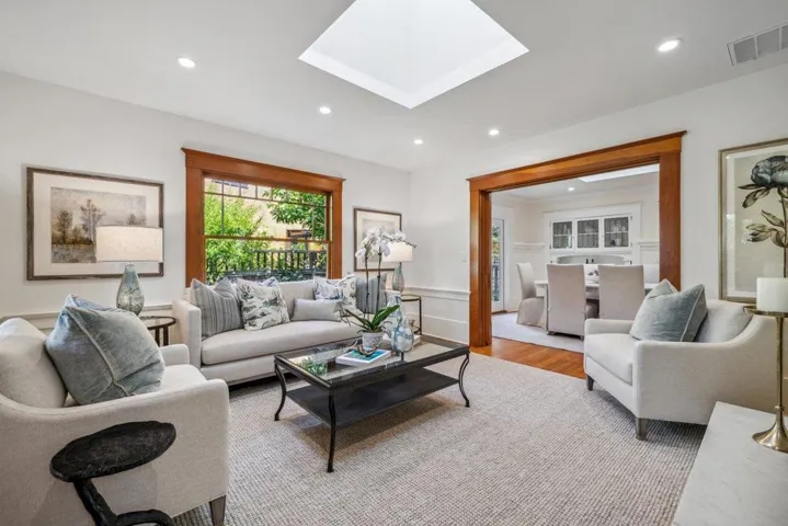 bright living room with polished wood trim around doors.