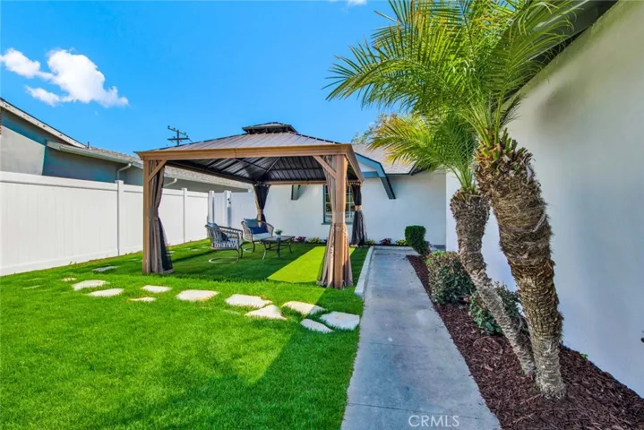 Park-Like Front Yard with Lush Lawn, Flowering Planters, and a New Sprinkler System!