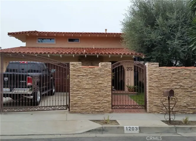 Front of Home with Driveway and Yard gate